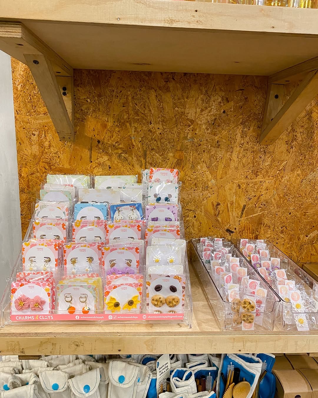 Charms and Clays product shelf at partner store showing variety of packaged earring sets